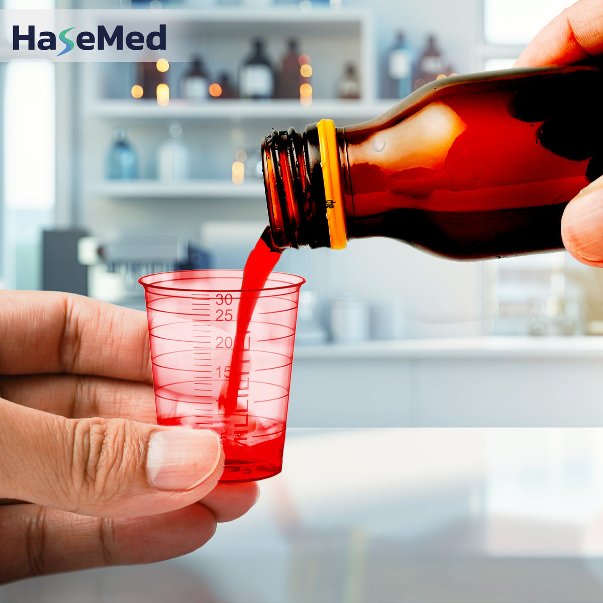 Red HaseMed 30 ml medicine cup in use; sold as 80 cups of one colour, without lids. Liquid and bottle not included.