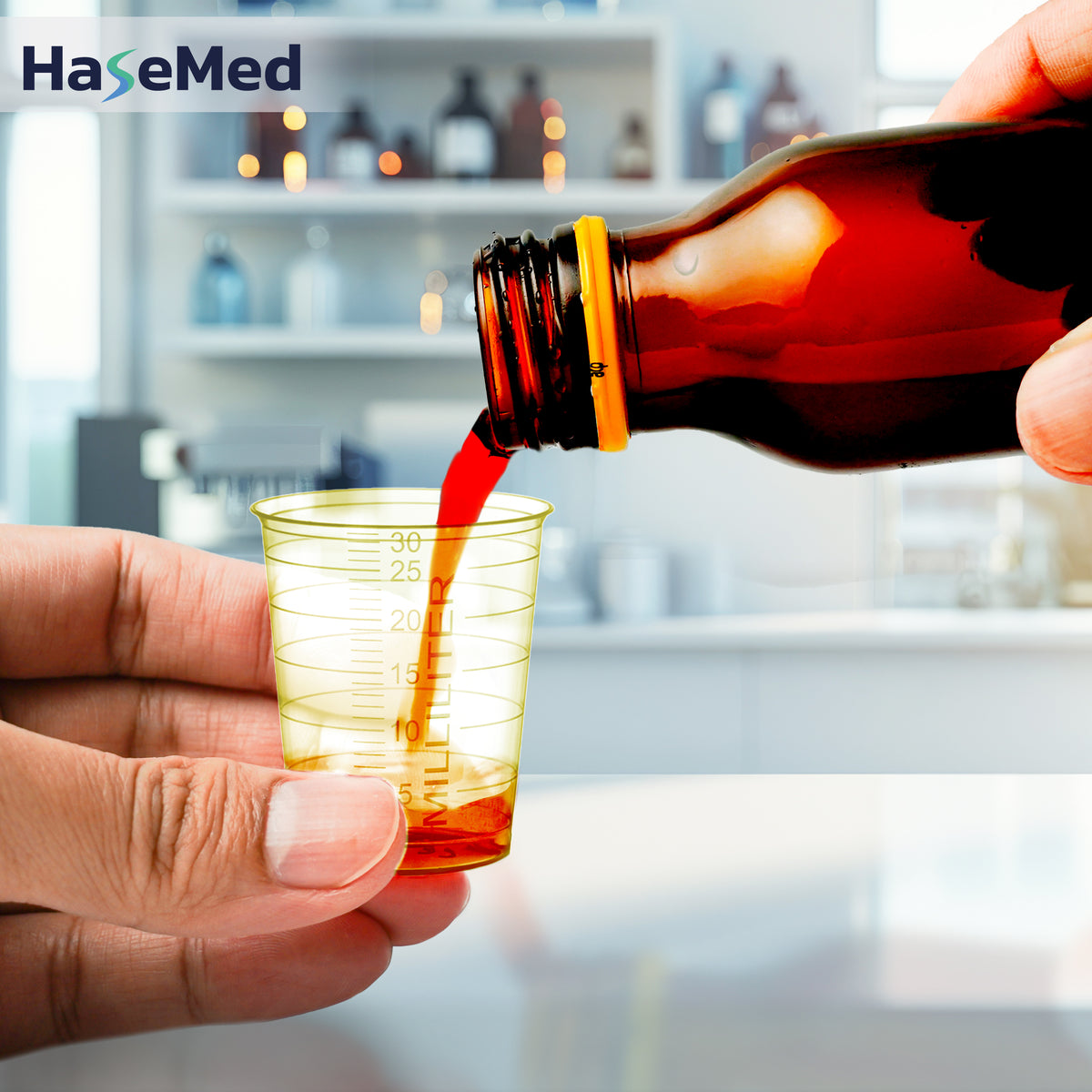 Yellow HaseMed 30 ml medicine cup in use; sold as 80 cups of one colour, without lids. Liquid and bottle not included.